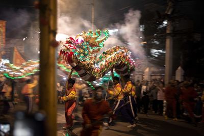 Group of people on street in city at night