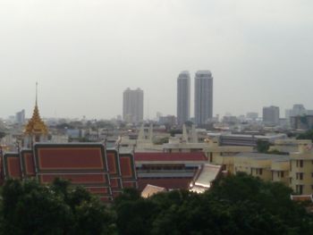 Buildings in city against sky