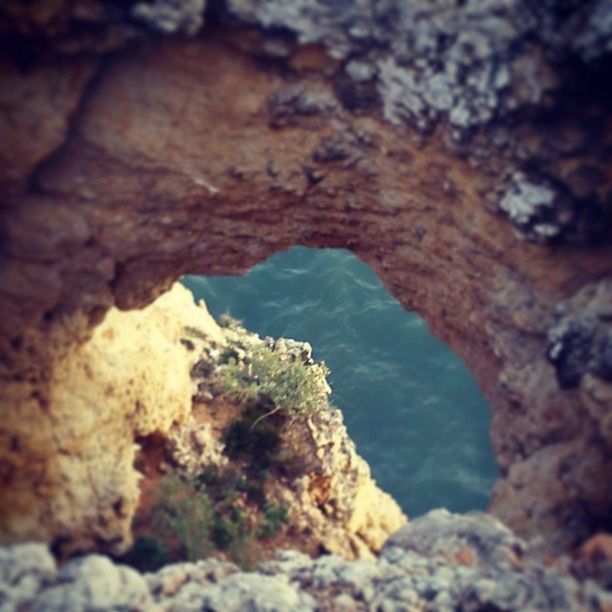 rock - object, rock formation, rock, rough, nature, water, textured, beauty in nature, tranquility, geology, high angle view, eroded, rocky, scenics, close-up, day, tranquil scene, cliff, outdoors, physical geography