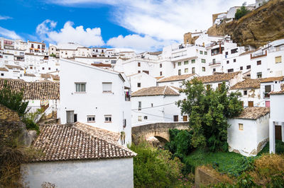 Houses in town against sky