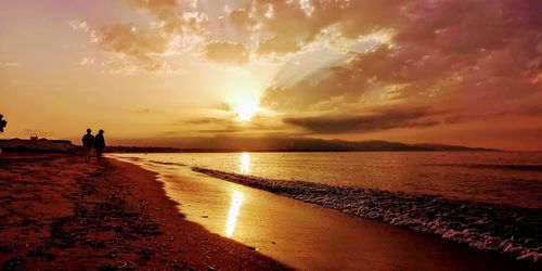 Scenic view of beach against sky during sunset