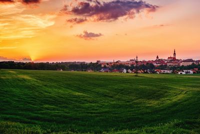 Scenic view of field against sky during sunset