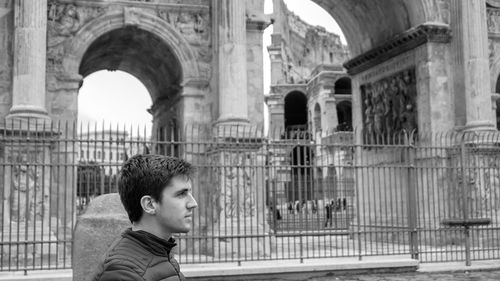 Portrait of boy looking through arch