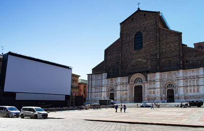 People outside building against clear sky