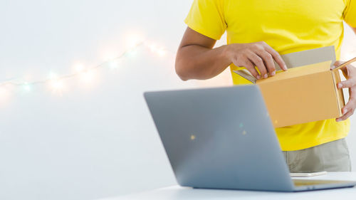 Midsection of woman working on table