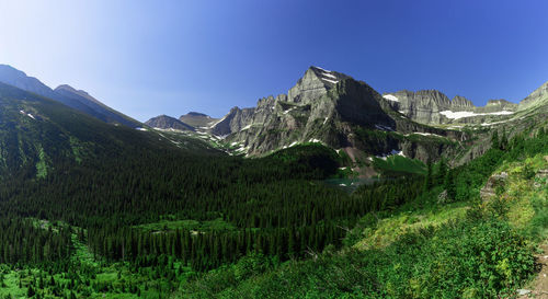 Scenic view of mountains against blue sky