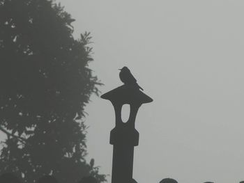 Low angle view of silhouette statue against clear sky