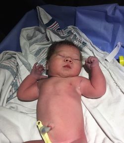 High angle view of baby girl lying on bed