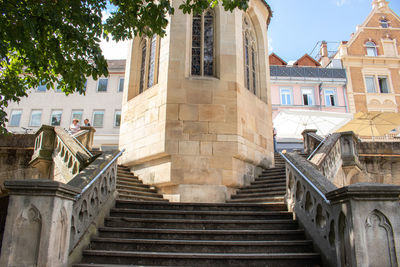 Low angle view of steps amidst buildings