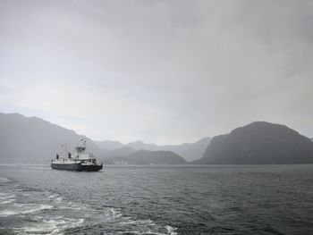 Ferry in sea against sky