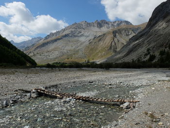 Scenic view of land and mountains against sky