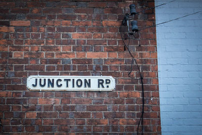 Close-up of text on brick wall