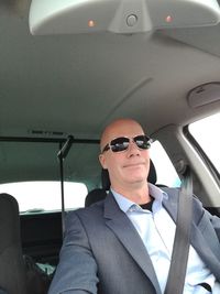 Man wearing sunglasses in car