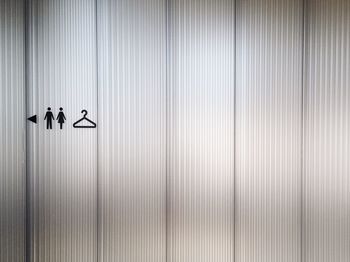 Changing room sign on white wall