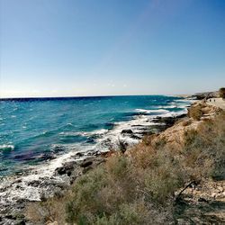 Scenic view of sea against clear blue sky