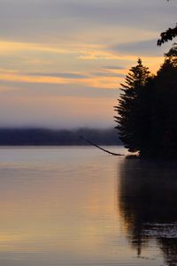 Scenic view of lake against orange sky