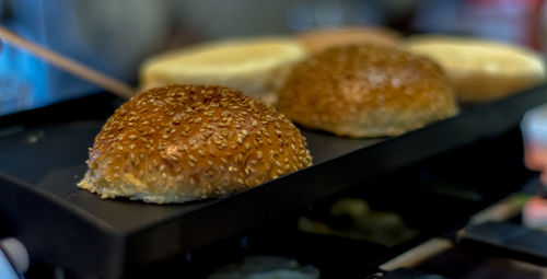 Close-up of burger buns on electric toaster