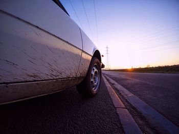 Car on street against sky during sunset