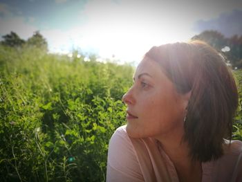 Close-up of beautiful woman on field against sky