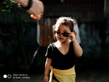 Portrait of man wearing sunglasses standing outdoors