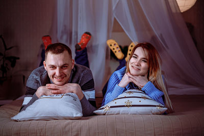 Friends lying on bed