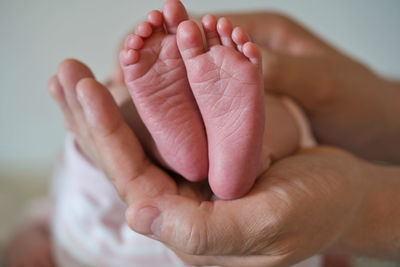 Close-up of baby feet on daddy hand