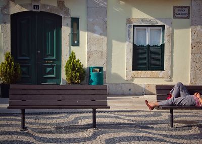 Boy sitting on sofa against built structure