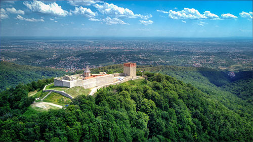 High angle view of trees and buildings against sky