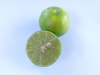 High angle view of green apple against white background