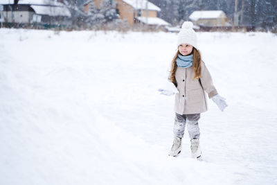 Rear view of woman standing in snow