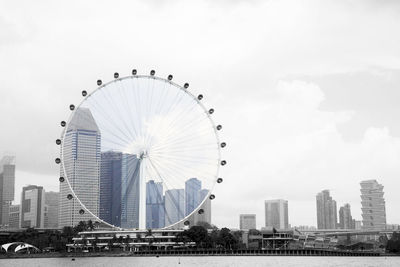 Ferris wheel in city against sky