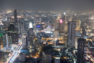 High angle view of illuminated city buildings at night