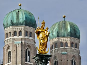 Statue of cathedral against buildings
