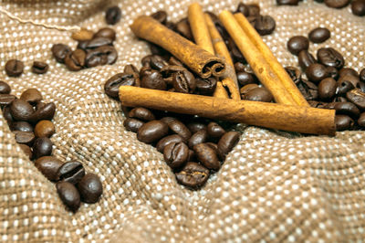 Full frame shot of coffee beans and cinnamon stick 