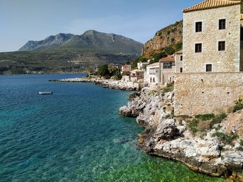 Scenic view of sea and buildings against sky