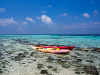 Kayks floating in bright turquoise water in the maldives