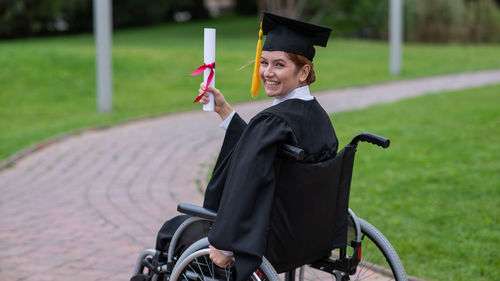 Young woman wearing graduation gown