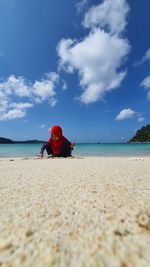 Malay girl playing with the sand at beach