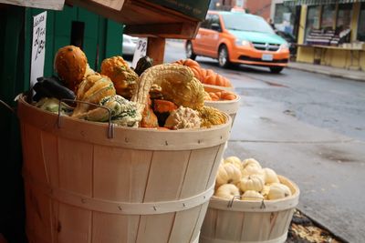 Vegetables in containers for sale at market stall