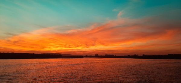 Scenic view of sea against romantic sky at sunset