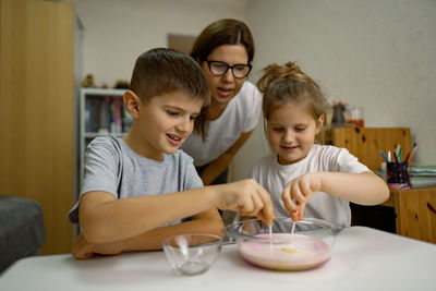 Mom and children are having fun at home, experimenting