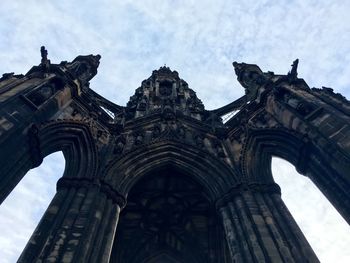 Low angle view of building against cloudy sky