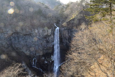 Scenic view of waterfall against sky