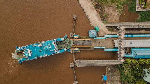 Hingh angle view from drone, showing us passenger ship dock in riversid of kapuas