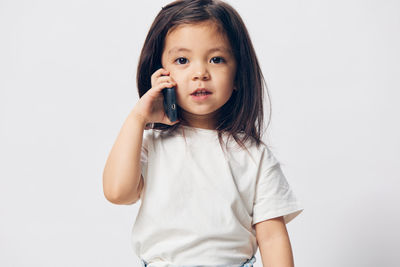 Portrait of young woman against white background