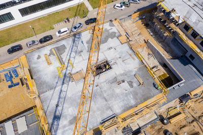 Worker is managing an elevated cherry picker at building site. aeria view