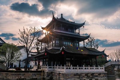 Low angle view of temple against cloudy sky