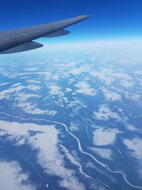 Aerial view of cloudscape over airplane wing