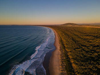 Scenic view of sea against clear sky during sunset