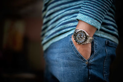 Midsection of woman standing against blurred background